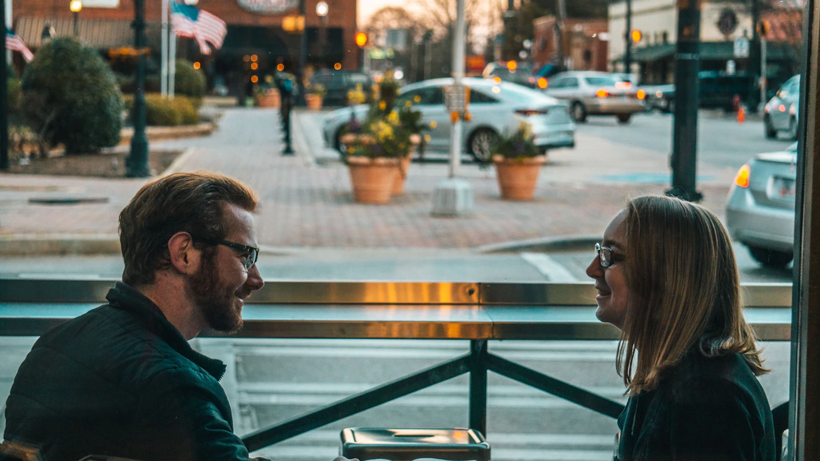 A couple talking together by a window