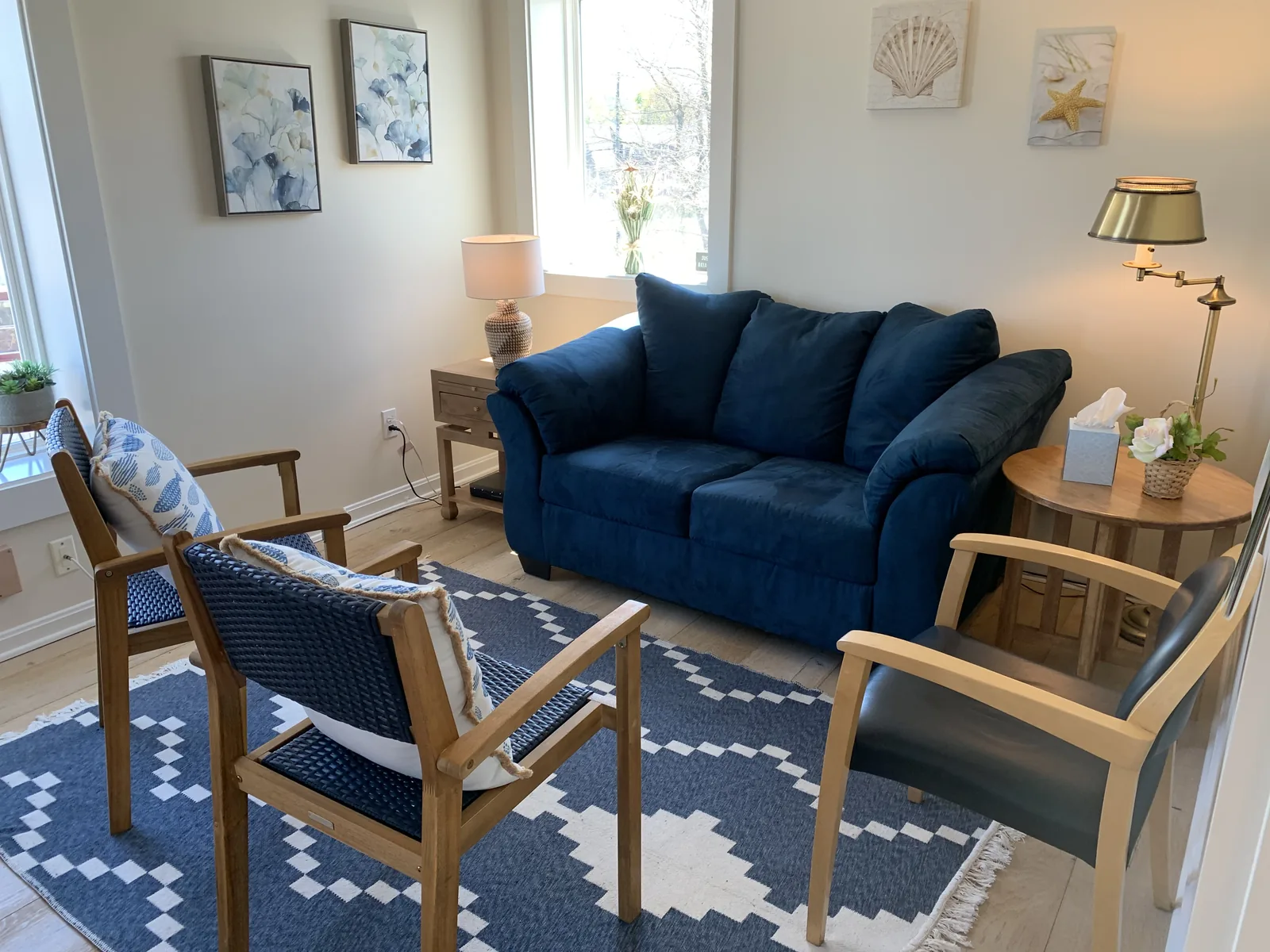 Hyannis center lounge with sofa, coastal artwork, and warm natural light