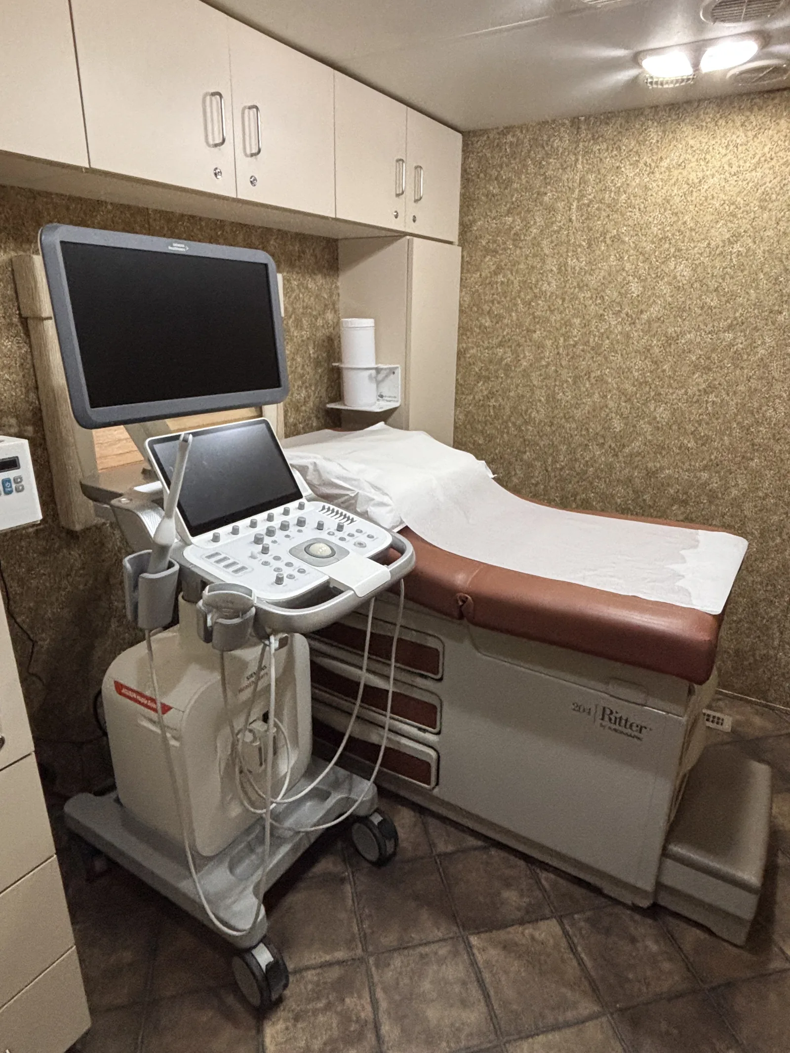 A sonographer performing a limited obstetric ultrasound on a pregnant patient